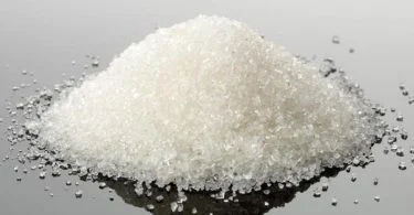 pile-of-white-granules-on-reflective-surface
