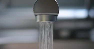 The main difference between water from a borehole and pipe-borne water is where it comes from and how it gets to people. Borehole water comes from underground aquifers and is taken to the surface through a drilled well, often with the help of a pump.